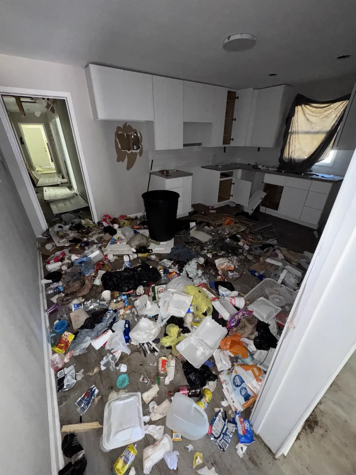 Kitchen before an Alexandria property cleanout with loose household debris