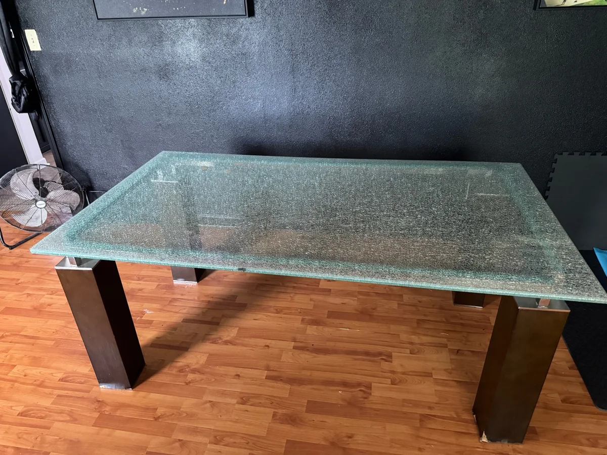 Large glass-top dining table before furniture removal.